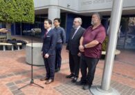 A group speaks in front of a court building in San Jose, California