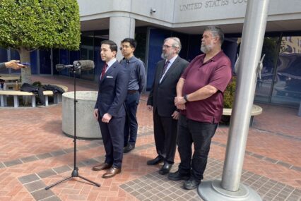 A group speaks in front of a court building in San Jose, California