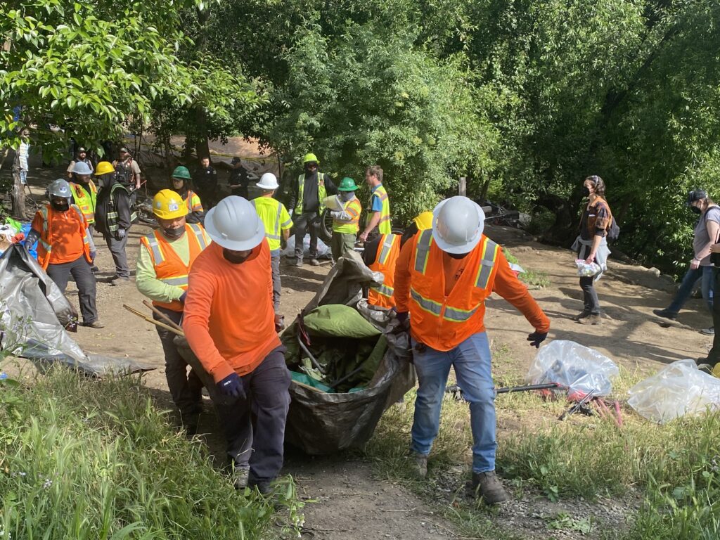 Workers clear a homeless encampment in San Jose