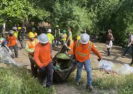 Workers clear a homeless encampment in San Jose