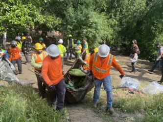 Workers clear a homeless encampment in San Jose