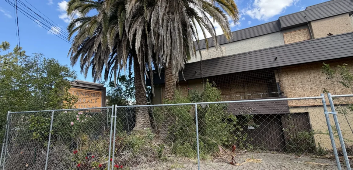 A shuttered hotel behind a fence in Palo Alto, California