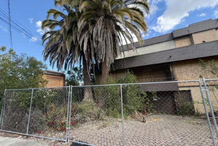 A shuttered hotel behind a fence in Palo Alto, California
