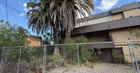 A shuttered hotel behind a fence in Palo Alto, California