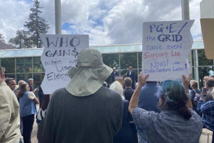 Rallygoers hold signs