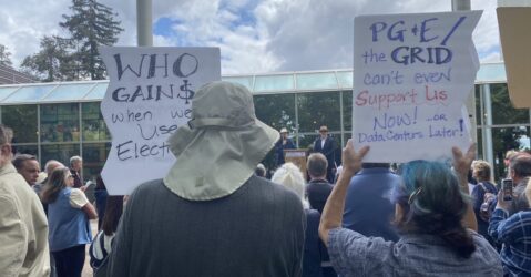 Rallygoers hold signs