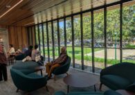 People sitting in chairs near a window at a library in Campbell, California