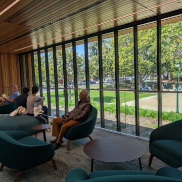People sitting in chairs near a window at a library in Campbell, California