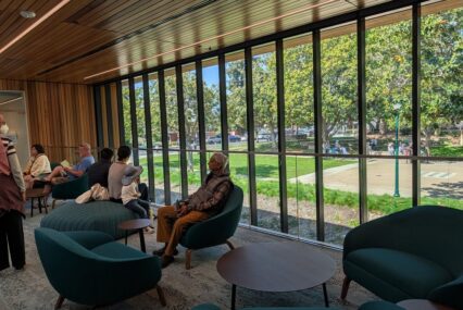 People sitting in chairs near a window at a library in Campbell, California