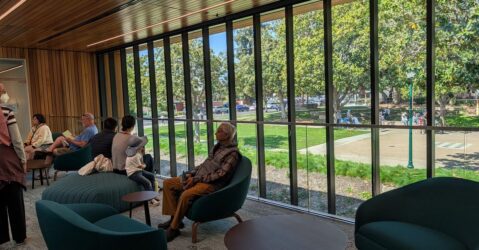 People sitting in chairs near a window at a library in Campbell, California
