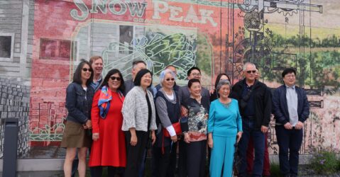 A group of people standing in front of a mural in Palo Alto, California