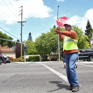 Palo Alto crossing guard Embarcadero A crossing guard holds a stop sign in the street in Palo Alto, California