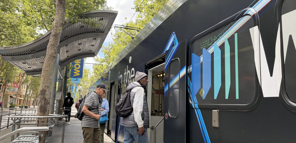People boarding a light rail train in downtown San Jose, California