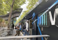 People boarding a light rail train in downtown San Jose, California