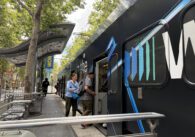 People boarding a light rail train in downtown San Jose, California