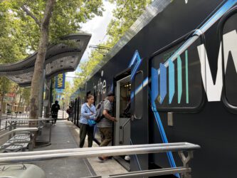 People boarding a light rail train in downtown San Jose, California
