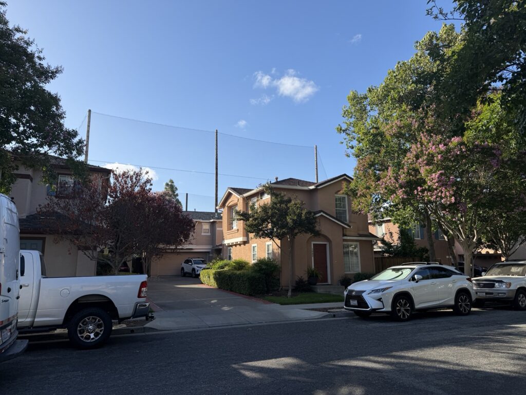 A home stands in front of a large net in San Jose, California