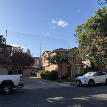 A home stands in front of a large net in San Jose, California