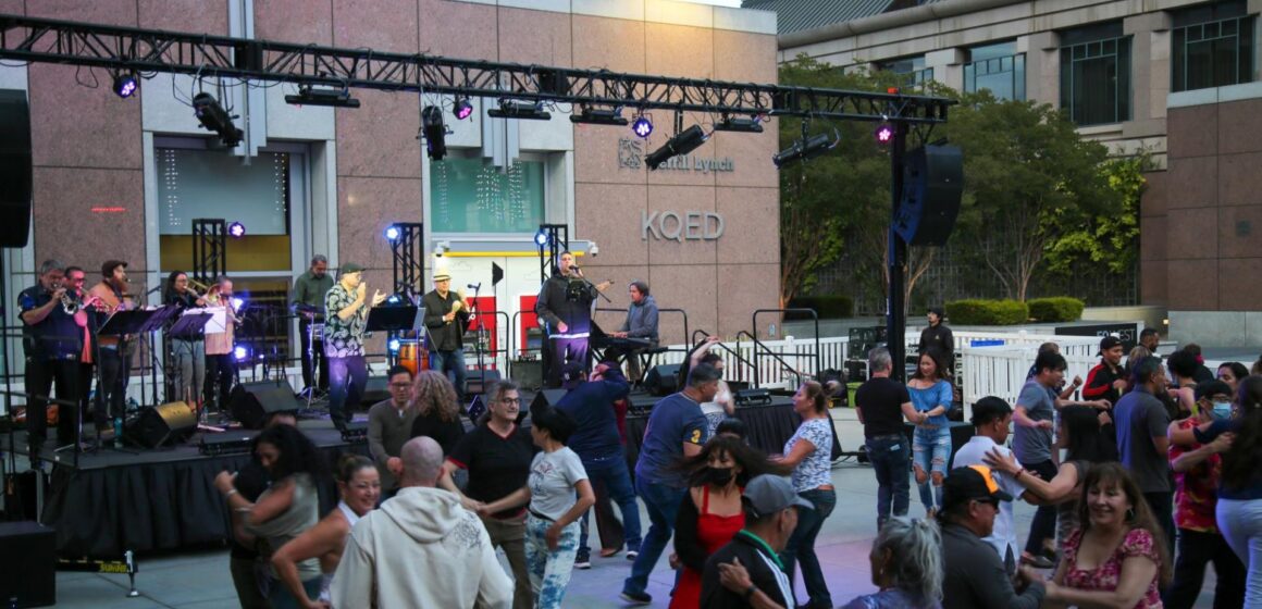 City Dance San Jose Urbanowski column People dancing in front of an outdoor stage in San Jose, California