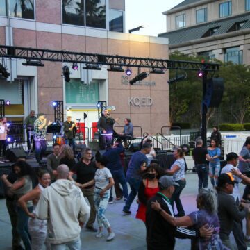 City Dance San Jose Urbanowski column People dancing in front of an outdoor stage in San Jose, California