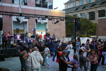 People dancing in front of an outdoor stage in San Jose, California
