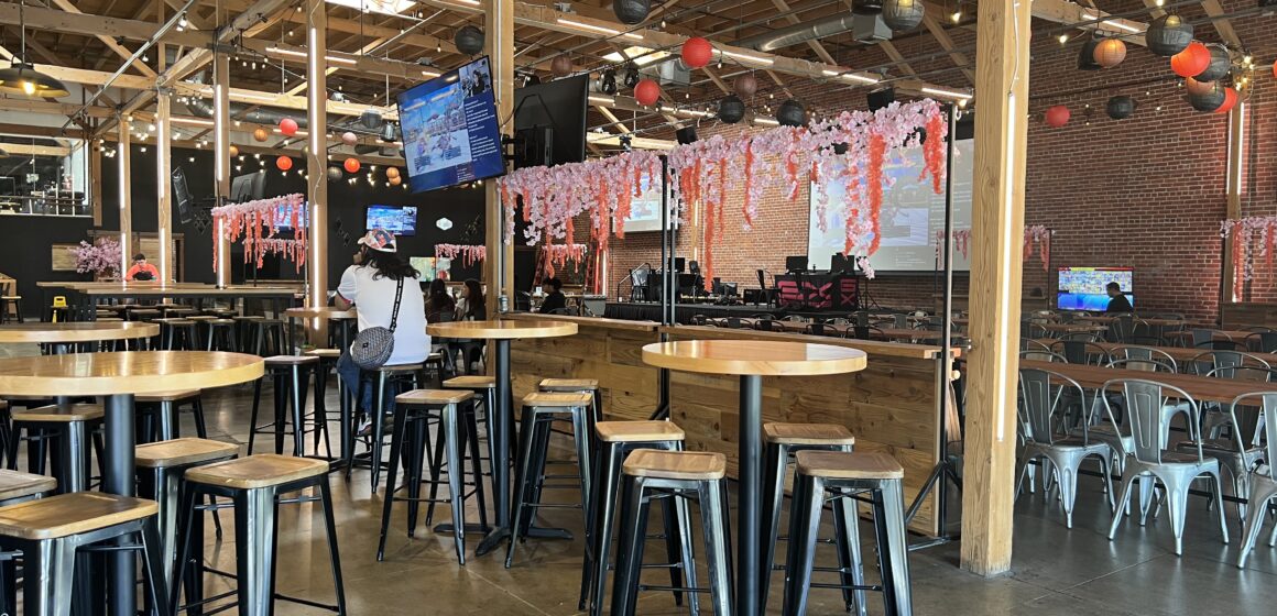 Interior of Guildhouse, an esports venue and sports bar, with seating areas and large screens.