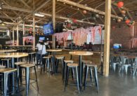 Interior of Guildhouse, an esports venue and sports bar, with seating areas and large screens.