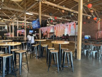 Interior of Guildhouse, an esports venue and sports bar, with seating areas and large screens.