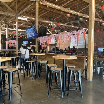 Interior of Guildhouse, an esports venue and sports bar, with seating areas and large screens.