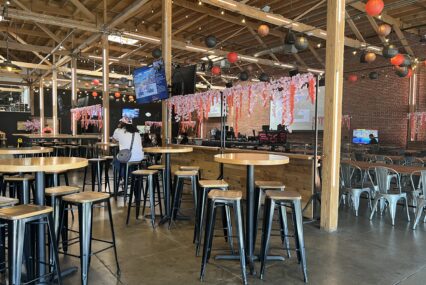 Interior of Guildhouse, an esports venue and sports bar, with seating areas and large screens.