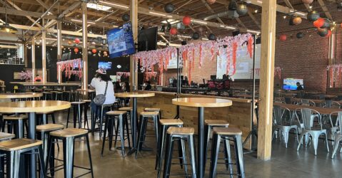 Interior of Guildhouse, an esports venue and sports bar, with seating areas and large screens.