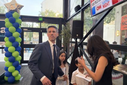 A man stands with a woman and two children in San Jose, California