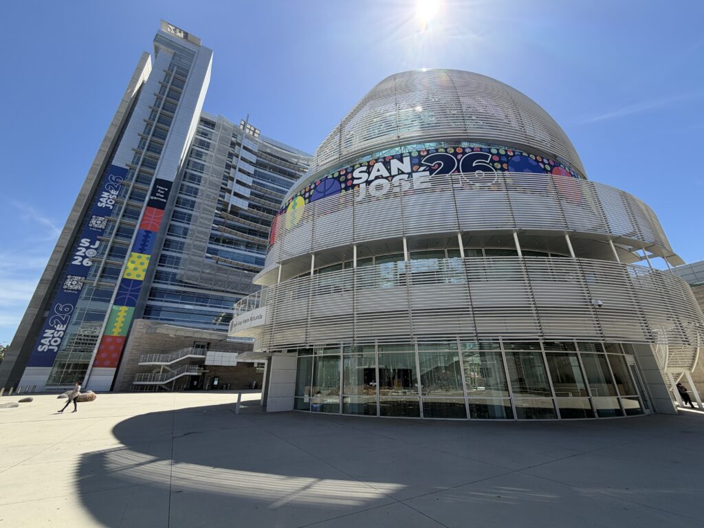 A women walks in front of a large government building in San Jose, California