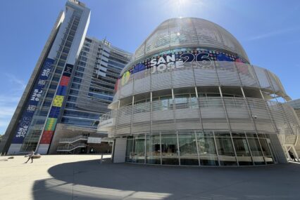 A women walks in front of a large government building in San Jose, California