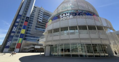 A women walks in front of a large government building in San Jose, California