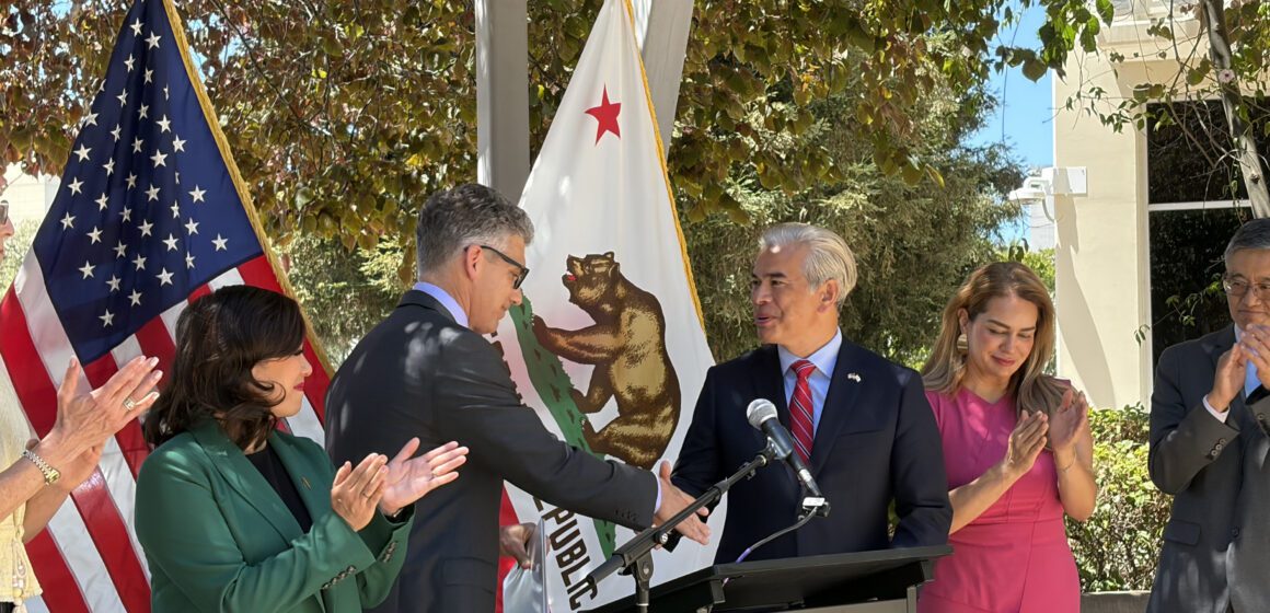 ICE FACILITY Two men shaking hands at a podium at a government press conference in San Jose, California