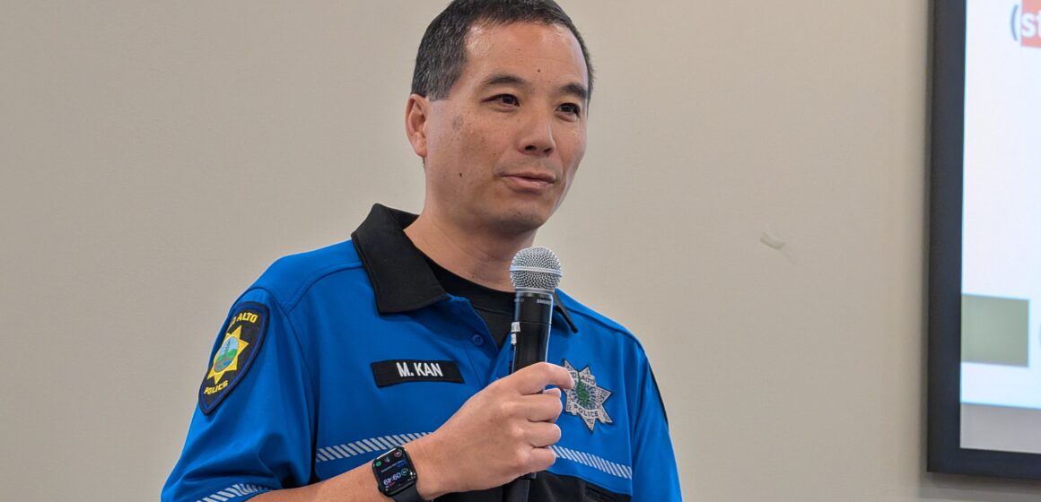 FRAUD PREVENTION A man in a police uniform speaking into a microphone