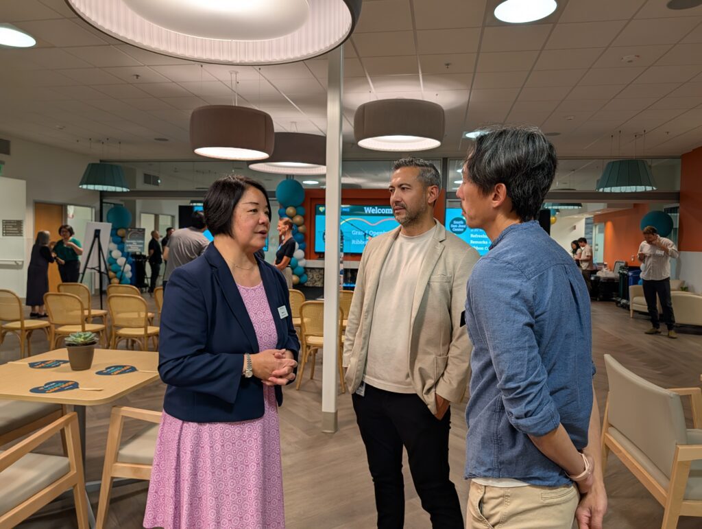 A woman speaks with two men inside a senior center in San Jose, California