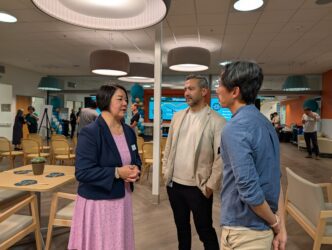 SENIOR PACE OPENING A woman speaks with two men inside a senior center in San Jose, California