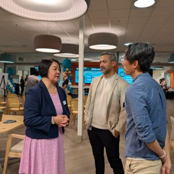 A woman speaks with two men inside a senior center in San Jose, California