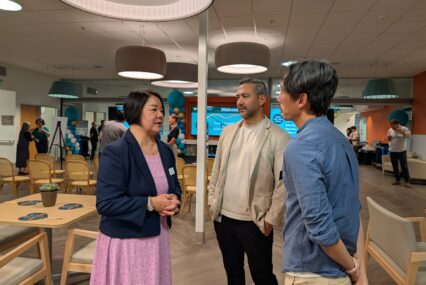 A woman speaks with two men inside a senior center in San Jose, California
