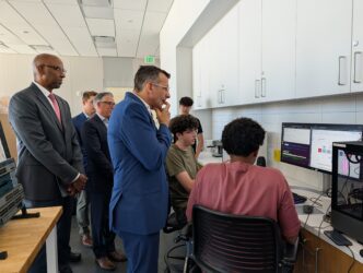 Liccardo AI Man looking at students studying in a room.