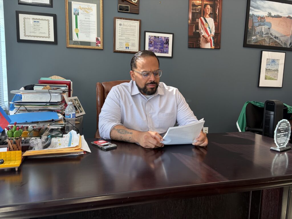 A man sitting at a desk looking at papers