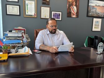 A man sitting at a desk looking at papers