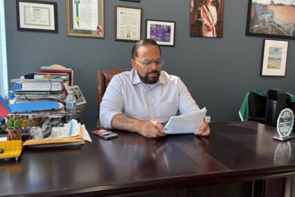 A man sitting at a desk looking at papers