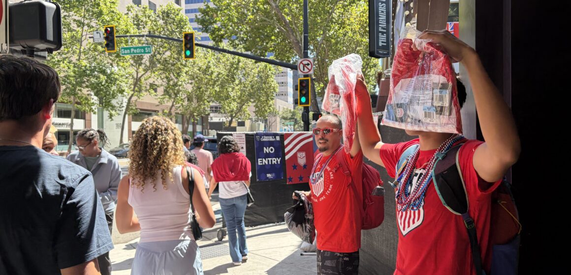 Downtown San Jose street vendors Two men selling soccer jerseys as people walk by in downtown San Jose, California