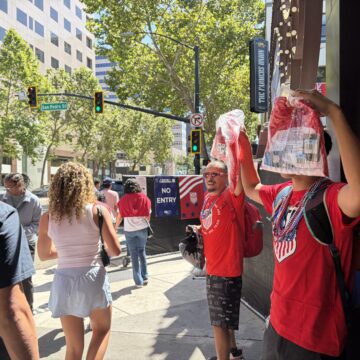 Downtown San Jose street vendors Two men selling soccer jerseys as people walk by in downtown San Jose, California
