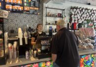 A barista behind a counter takes the order of a customer at a cafe in Gilroy, California