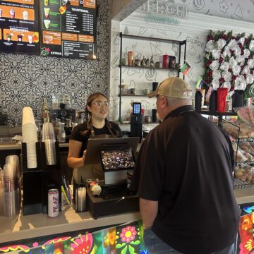 Con Azucar-Gilroy A barista behind a counter takes the order of a customer at a cafe in Gilroy, California