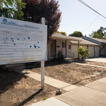 A development project sign in front of a home in Mountain View, California